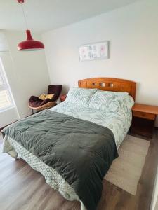 a bedroom with a bed and a red lamp at Papudo laguna in Papudo +14 photos