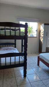 a bedroom with two bunk beds and a window at Nosso Lar casa inteira, completa e independente in Barra do Garças