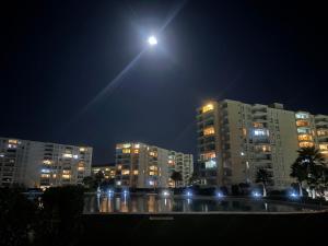 a moonlit city at night with tall buildings at Papudo laguna in Papudo