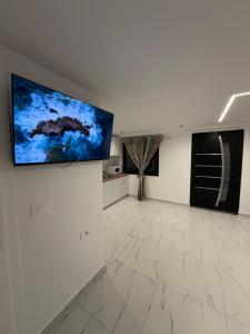 a living room with a flat screen tv on the wall at Happy Stayy in Patza-Kuqani
