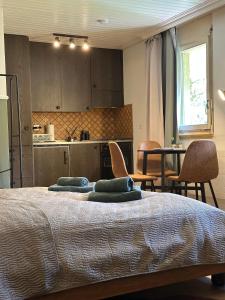 a bedroom with a bed and a table and chairs at Alpine Nest Tiltlis, Garden, Central, Lucerne in Engelberg