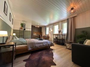 a bedroom with a large bed and a living room at Alpine Nest Tiltlis, Garden, Central, Lucerne in Engelberg
