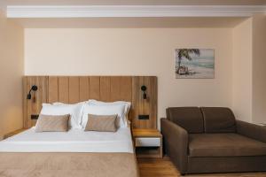 a bedroom with a bed and a couch at ARABESQUE Apartments & Suite in Ulcinj +101 photos