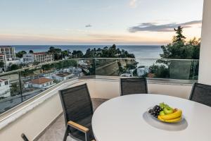 a table with a bowl of fruit on a balcony at ARABESQUE Apartments & Suite in Ulcinj