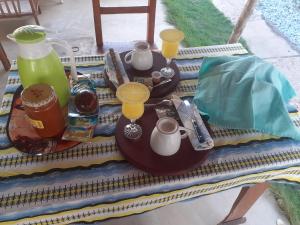 a picnic table with tea pots and cups on it at Résidence Stellahouado in Avlékété