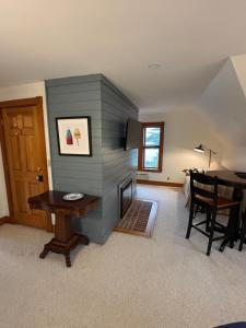 a living room with a blue wall and a table at Spouter Inn Bed & Breakfast in Lincolnville