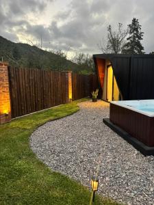a backyard with a hot tub and a fence at La Cautiva in Lozano