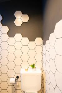 a bathroom with white tiled walls and a toilet at La Cautiva in Lozano +20 photos