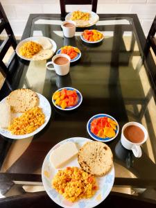 a glass table with plates of food on it at Antara del Mar in San Bernardo del Viento
