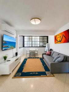 a living room with a couch and a table at Sea view panorama 62 in Haifa