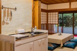 a kitchen with a sink and a table at 民泊YADOOR East House & West House in Iga +169 photos