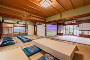 a room with a large table and some windows at 民泊YADOOR East House & West House in Iga
