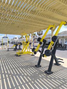 a row of yellow exercise bikes in a gym at Sea view panorama 62 in Haifa +1 photo