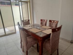 a dining room table and chairs with a view of a building at Casa independiente de 2 pisos con 03 cuartos in Morales