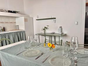 a table with plates and glasses and flowers on it at Cabaña Cali in Cafayate +8 photos