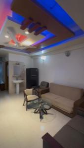 a living room with a couch and a table at Stay with Comfort in Cox's Bazar