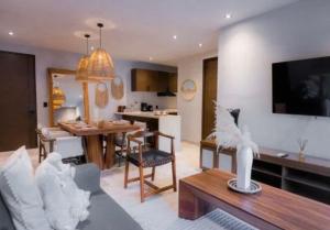 a living room with a kitchen and a dining room at Bakal Luxury Condos in Tulum