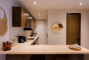 a kitchen with a large counter top in a room at Bakal Luxury Condos in Tulum