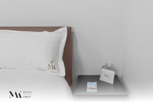 a bed with a white pillow and a side table at Walking Distance from Bayside Market Place - 501 First Residences Junior Studio Rooftop Pool in Miami +45 photos