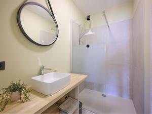 a bathroom with a sink and a mirror and a shower at Huus 16 in Zutendaal +39 photos