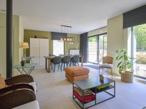 a living room with a couch and a table at Huus 16 in Zutendaal