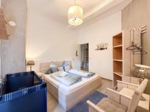 a bedroom with a bed and a couch and a chair at Quelle in Bernkastel-Kues