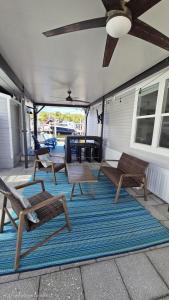 a group of chairs and tables on a patio at Happier in the Keys Waterfront Tiny Home in Key Largo