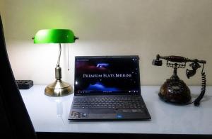 a laptop computer sitting on top of a desk with a lamp at Premium Flats Berrini - Boutique Hotel & Spa in São Paulo +81 photos