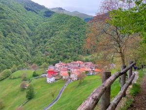 a village in the mountains with a fence at Panoramic lake view home's Giulia in Casasco Intelvi