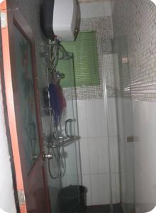 a shower with a glass door in a bathroom at Kadosh Homes - 2Bed Apartment in Magboro