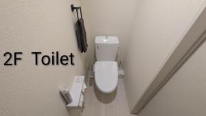 a bathroom with a toilet with the word tf toilet at 平宿 本山町ホテル in Kumamoto