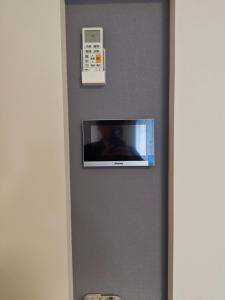 a television on a wall in a hotel room at StadtLeben東北ゲートウエイ2新築広々仙台駅徒歩5分 in Sendai