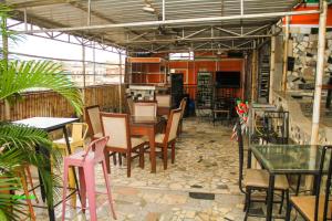 a restaurant with tables and chairs in a room at DeBoss Hotel in Ikeja