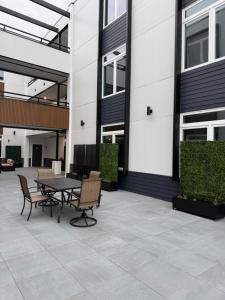 a patio with a table and chairs next to a building at Coral Sands in Seaside Heights