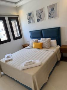 a bedroom with a bed with two towels on it at Cozy Flat Sea & Hills View in Marina Smir +28 photos