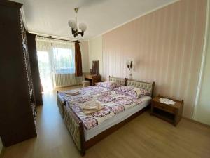 a bedroom with a large bed in a room at Apartment Gyenesdias 3 in Gyenesdiás +14 photos