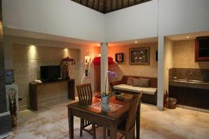 a living room with a table and a couch at The Buah Bali Villas in Seminyak