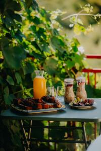 a table with two plates of food and orange juice at Aluna Camp in Nudo