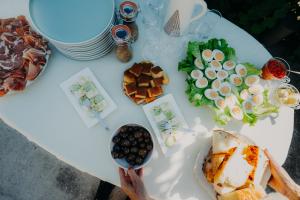 a table with plates of food on top of it at Aluna Camp in Nudo