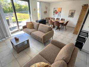 a living room with a couch and a table at Park Brekkense Wiel 190 in Lemmer +15 photos