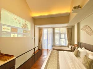 a hotel room with a large bed and a couch at Baliris Home Boutique Legian in Seminyak