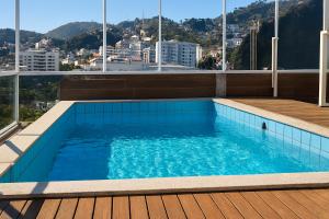 a swimming pool on the roof of a building at Refúgio Aconchegante Montanhas Capixabas 2 Quartos in Marechal Floriano