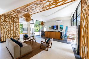 a living room with a couch and chairs at Private Pool with Beach Access and Baby Crib - Tulum Hotel Zone in Tulum