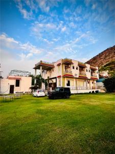 a building with a truck parked in front of it at Hotel & Resort Virasat inn in Alwar