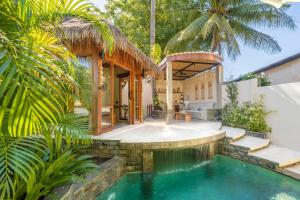 a house with a swimming pool in the yard at MELO Gili Air in Gili Islands