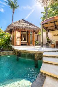 a villa with a swimming pool and a hut at MELO Gili Air in Gili Islands