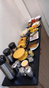 a table with a bunch of different types of food at Pousada Novo Sol in Solânea