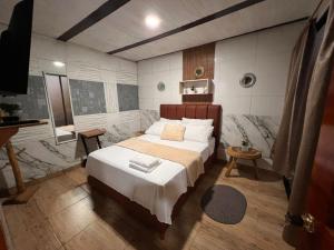 a bedroom with a large bed in a room at Hospedaje Salento in Salento +12 photos