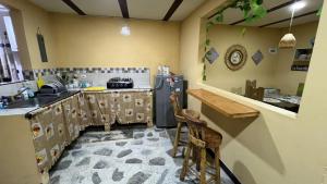a kitchen with a counter and a refrigerator at Hospedaje Salento in Salento