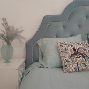 a bed with a metal headboard and a pillow on it at Sultana in Ech Chorfa